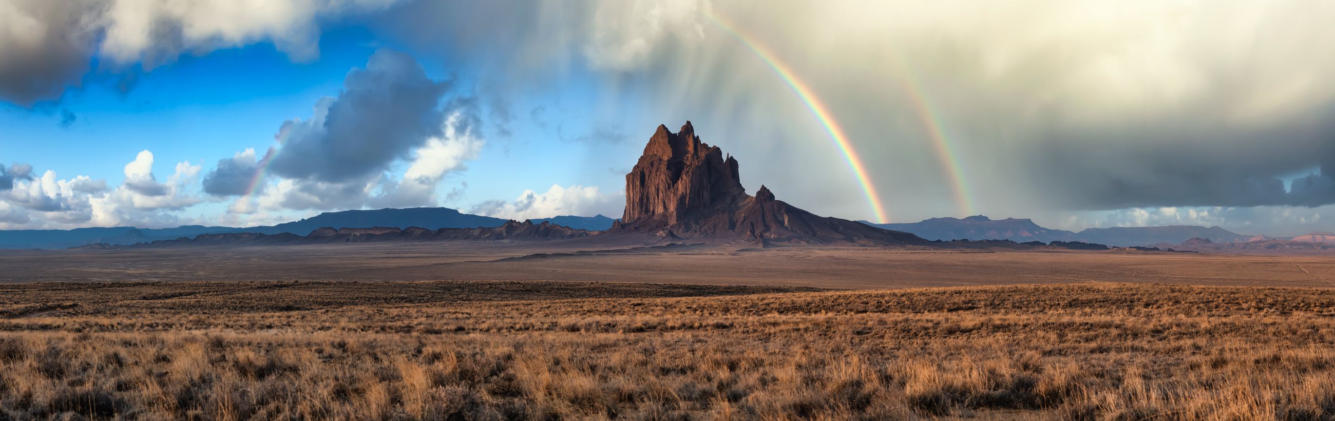 A double rainbow arcs over Shiprock in the high desert of Northern New Mexico
